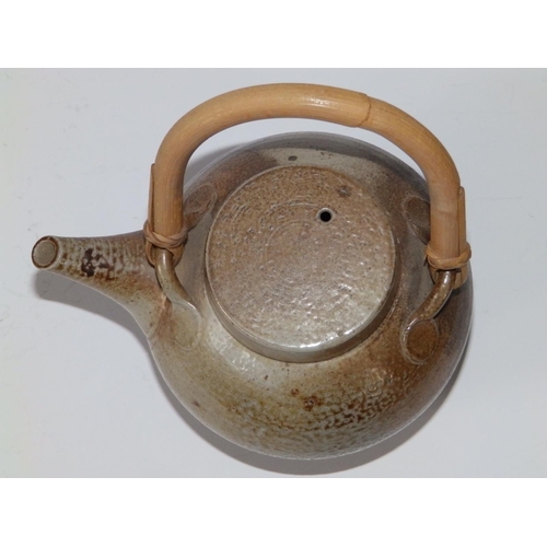 29 - A saltglazed studio teapot with tapering spout, U-shaped bamboo handle - 'HC?' monogram,  7.5