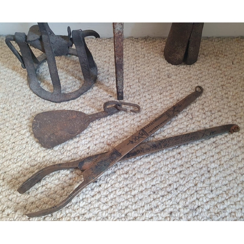 61 - An African iron lamp and other related items, the tallest 28