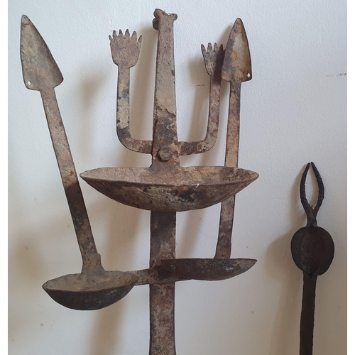 61 - An African iron lamp and other related items, the tallest 28