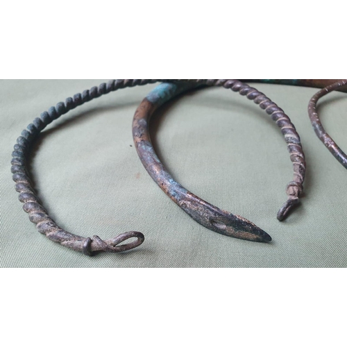 65 - Three Iron Age copper alloy torcs, the largest of solid construction, 8.25