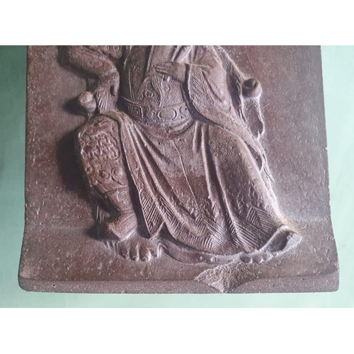 55 - A Chinese stone (?) plaque depicting an Immortal, 5.75