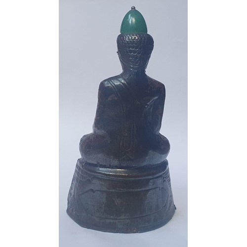 59 - An Asian silver covered Buddha with applied jade panel and hat, 5.2