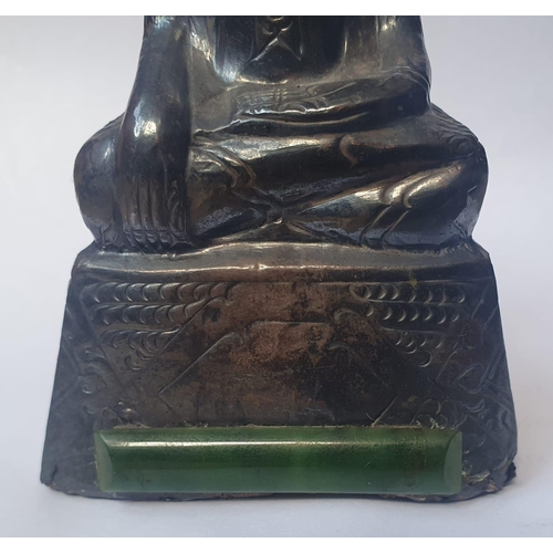 59 - An Asian silver covered Buddha with applied jade panel and hat, 5.2