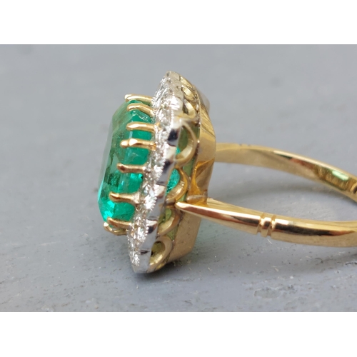 298 - A large rectangular emerald & diamond cluster ring, on yellow '18ct shank.  Finger size P/Q.