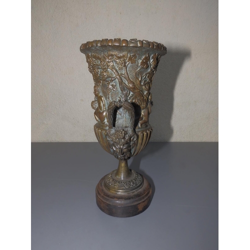 109 - A bronze campana shaped urn decorated bacchanalian putti, 9