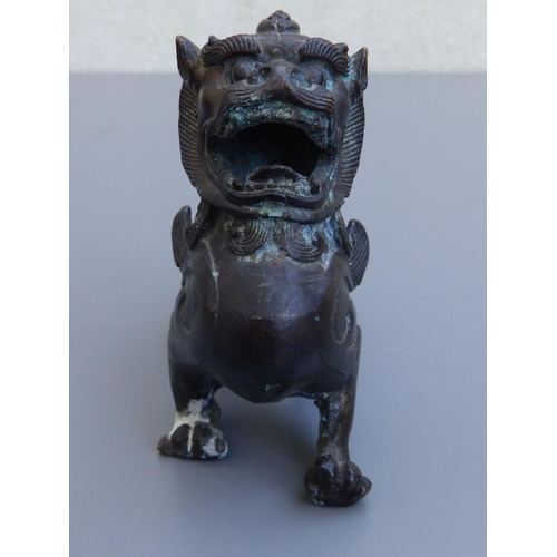 114 - A small Chinese bronze study of a shishi, 4