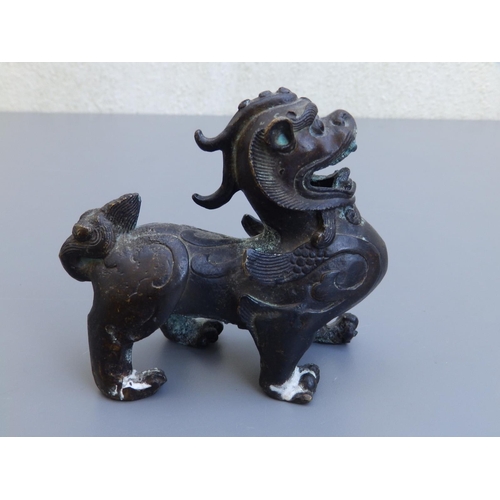 114 - A small Chinese bronze study of a shishi, 4