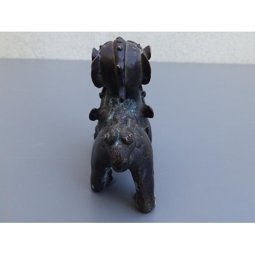 114 - A small Chinese bronze study of a shishi, 4