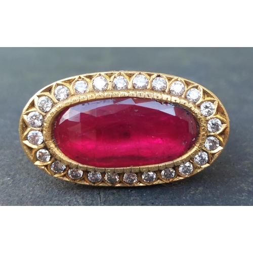 297 - A large antique style oval natural ruby & diamond cluster ring in 18ct gold, the faceted ruby weighi... 