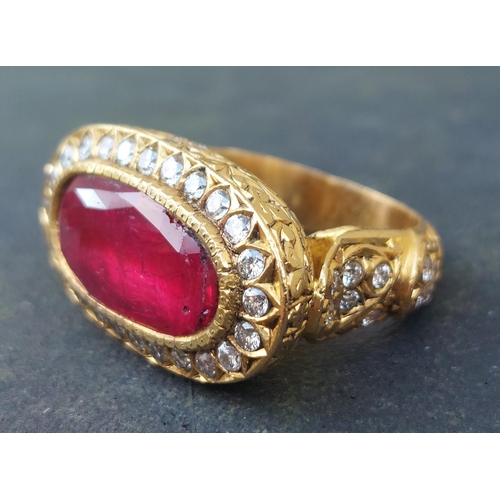 297 - A large antique style oval natural ruby & diamond cluster ring in 18ct gold, the faceted ruby weighi... 