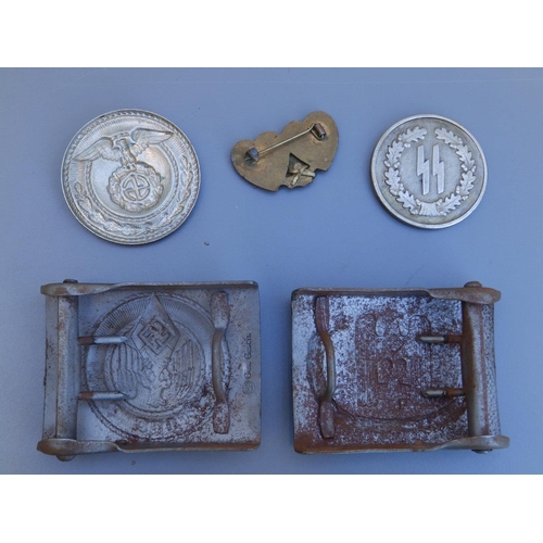 133 - Two WWII German buckles, two medallions and a Fleet Air Arm sweetheart brooch. (5)