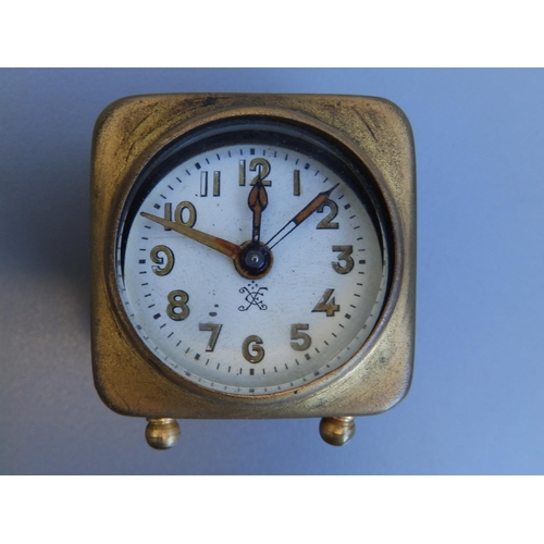 135 - A small gilt metal continental carriage/travel clock in folding leather covered case, the clock 1.8