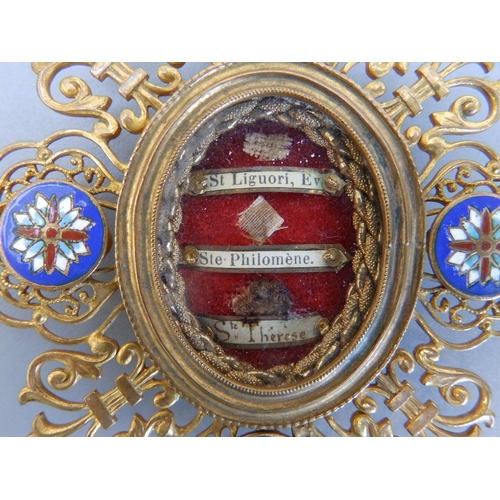 151 - A small antique enamelled & gilt metal pendant reliquary, venerating the Saints Liguori, Philomene a... 