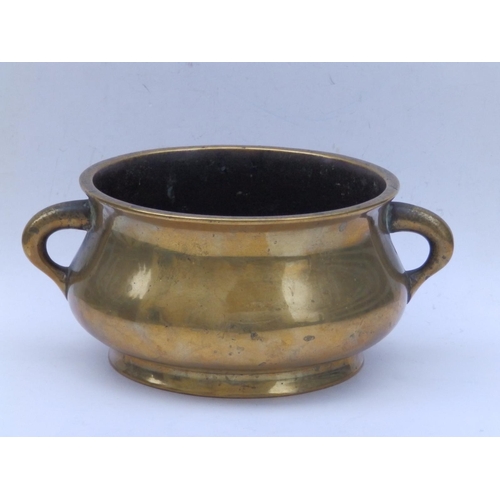 152 - A Chinese bronze two-handled censer, the underside cast with six character reign mark within a drago... 