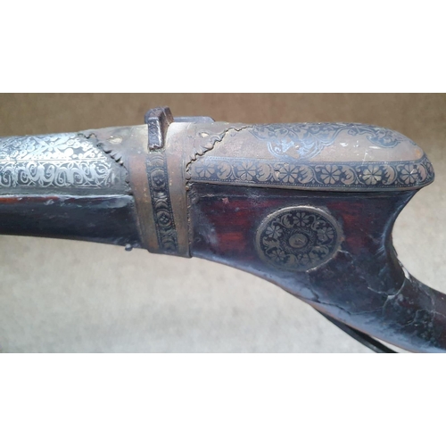 123 - An Arab Jezail long gun, the wooden stock with well decorated mounts, silver inlay to barrel, 63