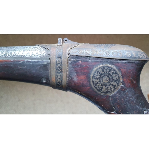 123 - An Arab Jezail long gun, the wooden stock with well decorated mounts, silver inlay to barrel, 63