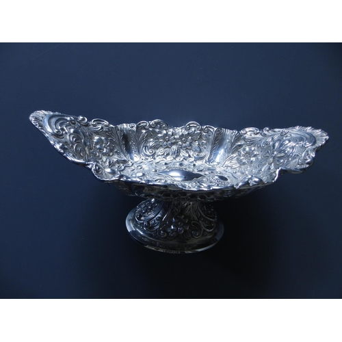 164 - A late Victorian silver repousse canoe-shaped silver pedestal bowl - Mappin Brothers, London 1897,  ... 