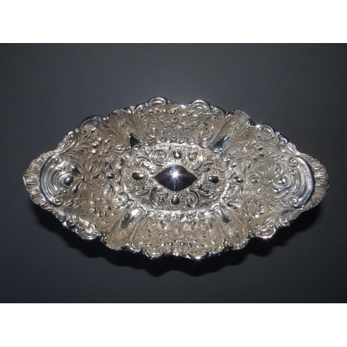 164 - A late Victorian silver repousse canoe-shaped silver pedestal bowl - Mappin Brothers, London 1897,  ... 