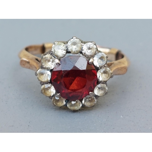 235 - A garnet & white sapphire cluster ring.