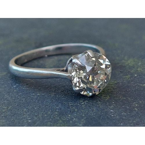 303 - An old cut diamond solitaire ring, the claw set stone weighing approximately 1.7 carats on white met... 