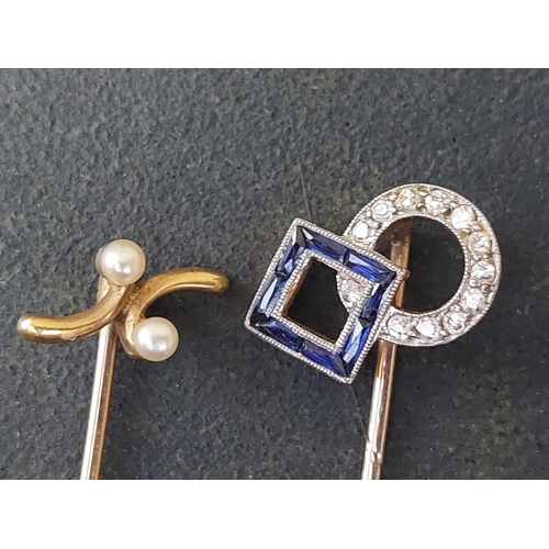 231 - A sapphire & diamond set stick pin and one other. (2)