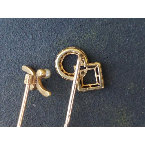 231 - A sapphire & diamond set stick pin and one other. (2)