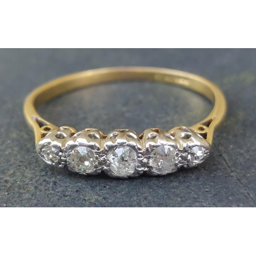 243 - A small five stone graduated diamond ring in 18ct & PT.  Finger size O.