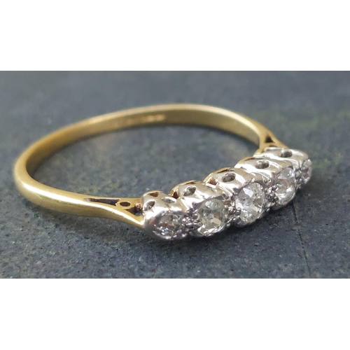 243 - A small five stone graduated diamond ring in 18ct & PT.  Finger size O.