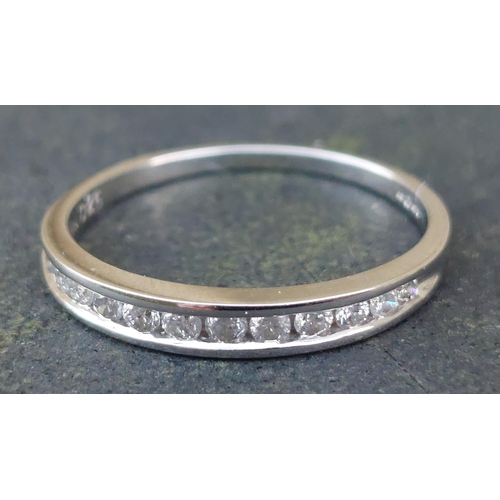 244 - A modern diamond set half eternity 18ct white gold ring, total diamond weight 0.25 carat.  Finger si... 