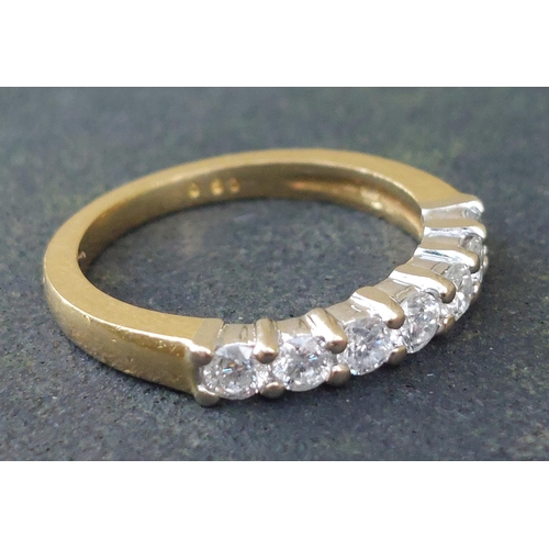 245 - A modern seven stone diamond in 18ct gold - total diamond weight 0.50 carat.  Finger size I/J.