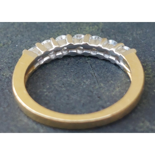 245 - A modern seven stone diamond in 18ct gold - total diamond weight 0.50 carat.  Finger size I/J.