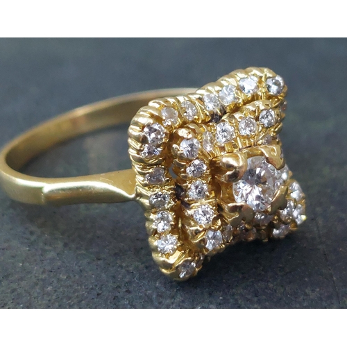 246 - A modern diamond cluster ring of shaped square form on 18ct gold shank.  Finger size M/N.