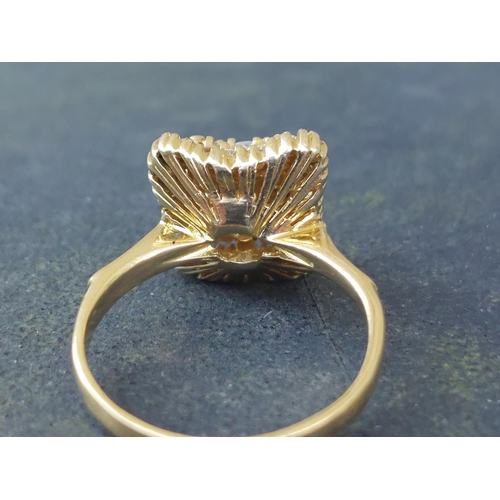 246 - A modern diamond cluster ring of shaped square form on 18ct gold shank.  Finger size M/N.