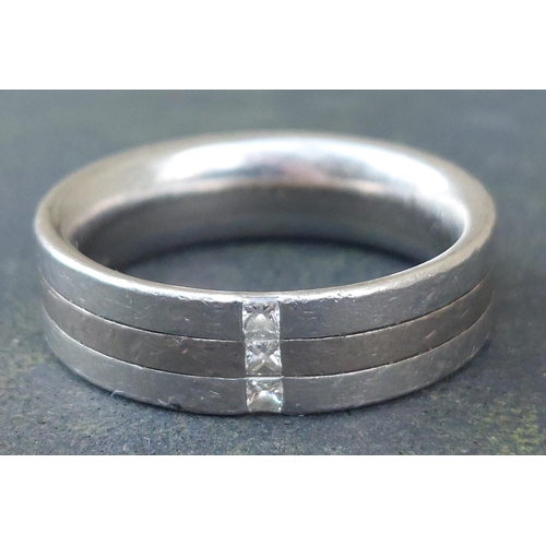 248 - A gent's  platinum & 18ct  gold band ring with textured finish, set transversely with three small di... 