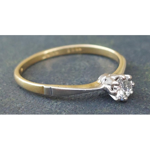 250 - A small diamond solitaire ring in 18ct & PLAT.  Finger size M.