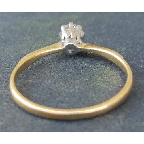 250 - A small diamond solitaire ring in 18ct & PLAT.  Finger size M.