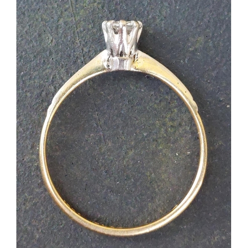 250 - A small diamond solitaire ring in 18ct & PLAT.  Finger size M.