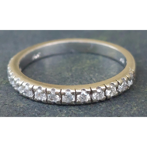 251 - A diamond half eternity ring set with 12 stones in white 14k.  Finger size N/O.