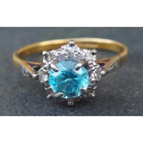 254 - A small blue stone & diamond cluster ring in 18ct & PLAT.  Finger size L.