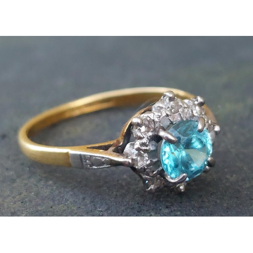 254 - A small blue stone & diamond cluster ring in 18ct & PLAT.  Finger size L.