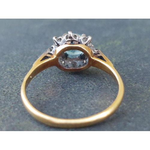 254 - A small blue stone & diamond cluster ring in 18ct & PLAT.  Finger size L.