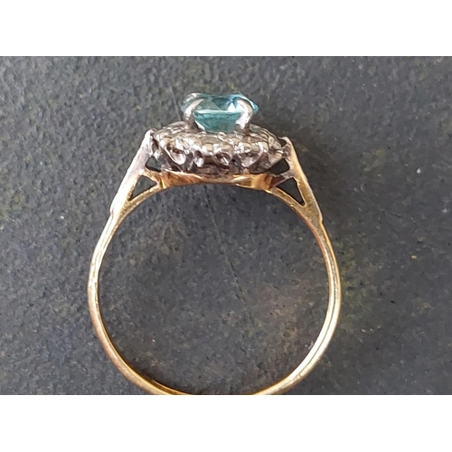 254 - A small blue stone & diamond cluster ring in 18ct & PLAT.  Finger size L.