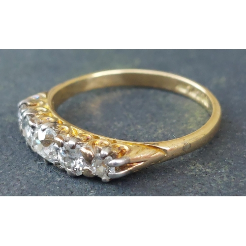 255 - A five stone graduated old cut diamond ring in 18ct & PLAT.  Finger size N.