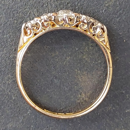 255 - A five stone graduated old cut diamond ring in 18ct & PLAT.  Finger size N.