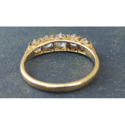 255 - A five stone graduated old cut diamond ring in 18ct & PLAT.  Finger size N.