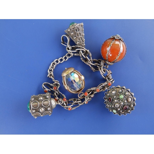 280 - A silver charm bracelet with one gold charm.