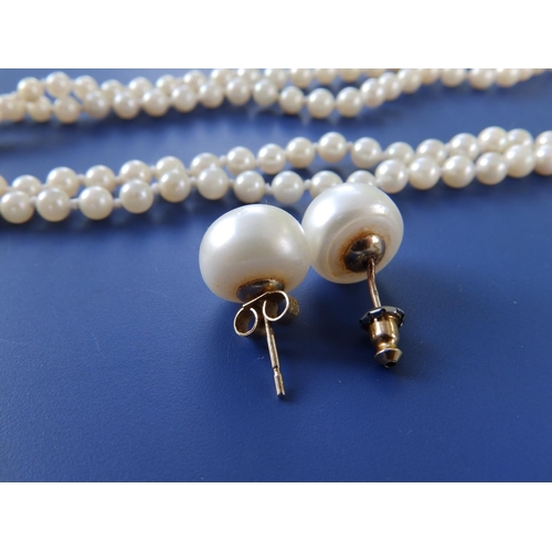 282 - A graduated pearl twin strand necklace with yellow metal clasp and a pair of button pearl earrings, ... 