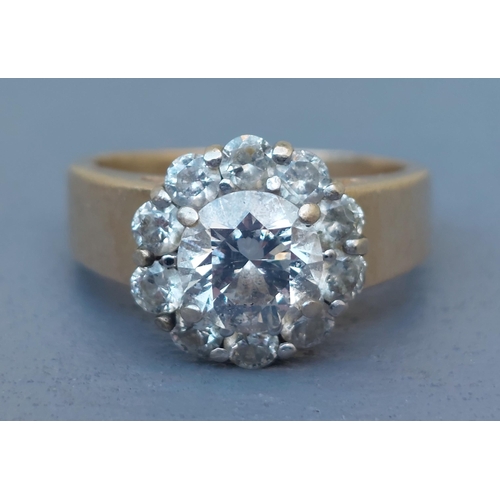 311 - A modern diamond cluster ring, the central claw set brilliant weighing approximately one carat, on y... 