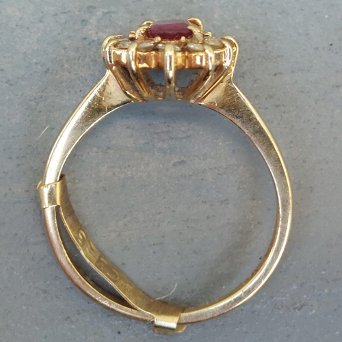 257 - An oval ruby & diamond cluster ring in 9ct gold.