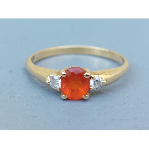 259 - A small Mexican fire opal & diamond three stone ring on 18ct gold shank.  Finger size Q.